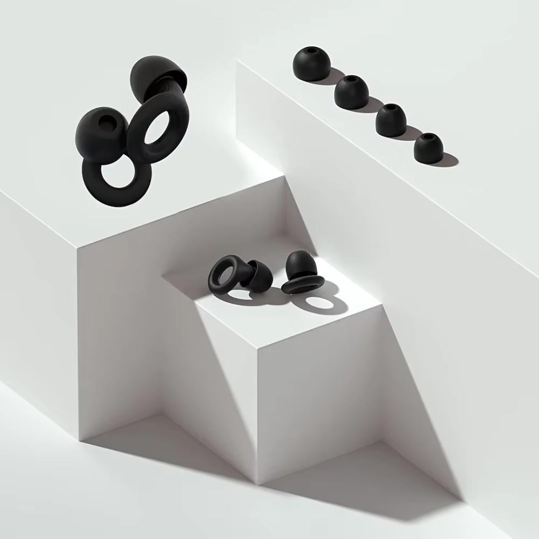 Two pairs of black earplugs with four tip sizes on blocks